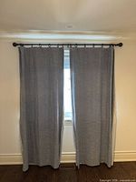 Front view of both curtain panels hanging on rod