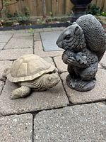 Lot overview showing both turtle and squirrel statues on patio