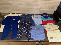 All 10 preemie clothing items arranged on counter