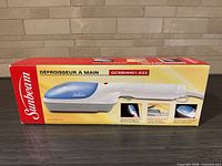 Retail box showing Sunbeam GCSBHH01-033 steamer image and branding
