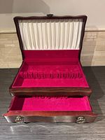 Box open showing interior velvet and satin lining with slotted compartments