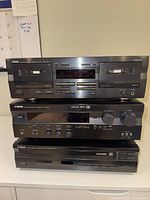 Front view showing stacked cassette deck, receiver, and CD player