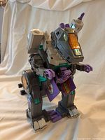 Front view of Trypticon in dinosaur mode showing overall figure and colour scheme
