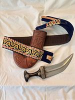 Dagger with scabbard and embroidered belt displayed