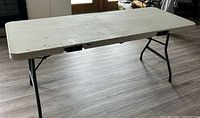 Full view of unfolded table showing top and legs