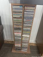 Full view of wooden CD tower filled with jewel cases