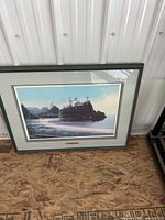 Front view of framed lithograph showing artwork, matting, green frame and brass title plaque