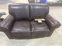 Front view of brown leather loveseat