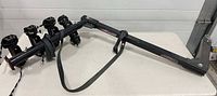 Full view of hitch rack showing cradle arms and strap