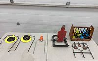 Overall view of all targets, launcher, stake and crate on table