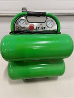 Front view of green Kawasaki twin-tank air compressor