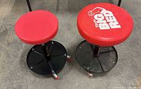 Both stools side by side showing seats, branding and bases