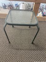Oblique view of entire table showing glass top and frame