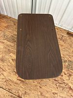 Top view of coffee table surface showing laminate wood-grain and pre-drilled holes