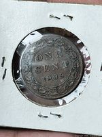 Reverse side showing ONE CENT 1909 with vine border
