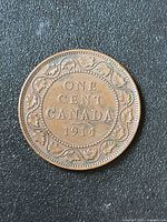 Reverse of 1914 Canada one cent coin on black background