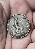 Reverse of 1921 one penny coin showing seated Britannia, denomination and date