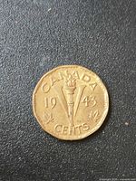 Reverse: 1943 Victory nickel showing torch, V, denomination