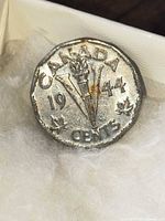 Reverse side showing torch, date 1944, inscription CANADA, denomination Cents
