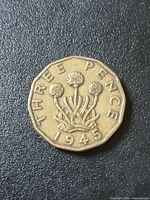 Reverse of coin showing thrift plant, date 1945, legend THREE PENCE