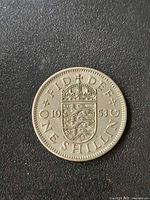 Reverse of 1953 one shilling coin showing crowned shield and FID DEF legend