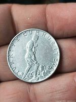 Obverse of 1965 2½ Lira coin showing figure and inscription