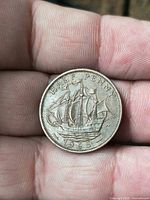 Reverse of 1965 half penny showing Golden Hind sailing ship, date 1965 visible