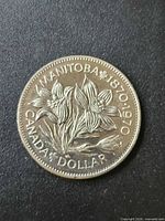 Reverse of coin displaying Manitoba Centennial design