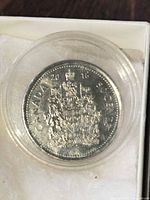 Reverse of 2016 Canadian dollar with Coat of Arms