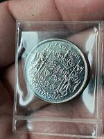 Reverse side showing Arms of Canada, 50 CENTS legend, date 2021, in plastic flip