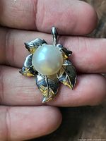 Front view of sterling silver leaf pendant with large pearl