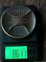 Obverse of medallion on scale showing 86.11 g