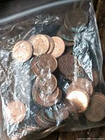 Plastic bag containing numerous Canadian 1 cent coins