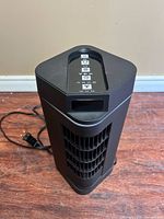 Front view of BlackStone 13" tower fan showing grille and compact size