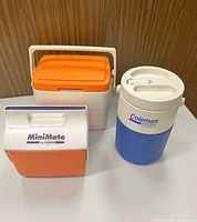 Front view of three coolers showing sizes, colors, brands