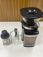 Grinder, Bodum mini press, glass cup grouped on tabletop