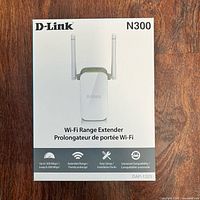 Front of sealed D-Link N300 Wi-Fi Range Extender box showing model and features