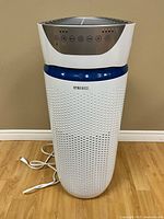 Full front view of HoMedics tower air purifier showing overall condition and power cord