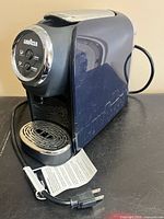 Three-quarter front view showing body, drip tray and cord