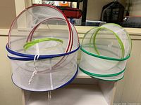 All five nested mesh covers standing on shelf