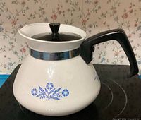 Front view showing blue Cornflower motif, lid, handle