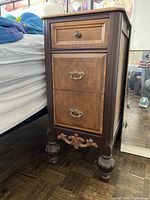 Full view of cabinet beside bed showing drawer arrangement and overall finish