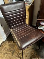 Front view of one chair showing overall style and upholstery