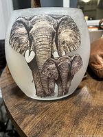 Front view of frosted glass vase with adult and calf elephant print