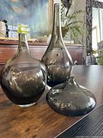 Group shot of all three smoky grey glass vases on table