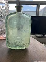 Light green rectangular embossed glass flask front view