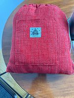 Red woven Da Buddha carry bag front view