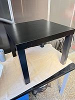 Overall view of black IKEA side table on towel