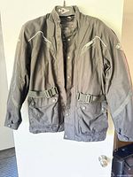 Front view of charcoal textile motorcycle jacket hanging