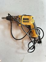 Full view of one DeWalt corded drywall screwdriver showing overall wear and power cord